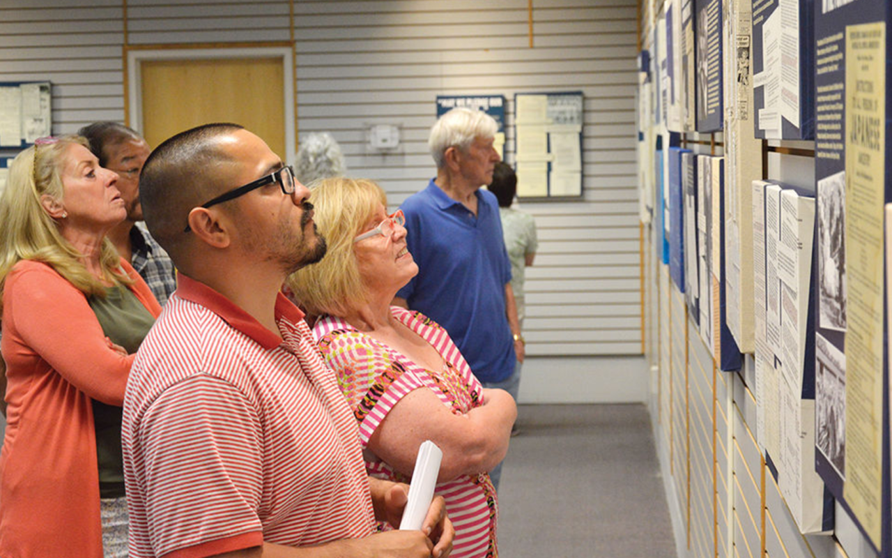 Residents from Ontario and surrounding communities peruse an exhibit on Japanese-American internment during its opening night at Four Rivers Culture Center's Harano Gallery. Photo credit: Hunter Morrow