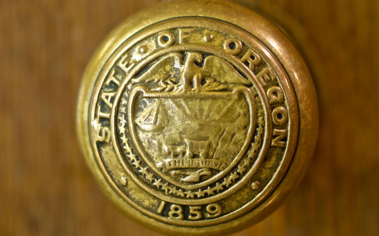 The handle of a doorknob at the Capitol building in Salem reads: State of Oregon – 1859