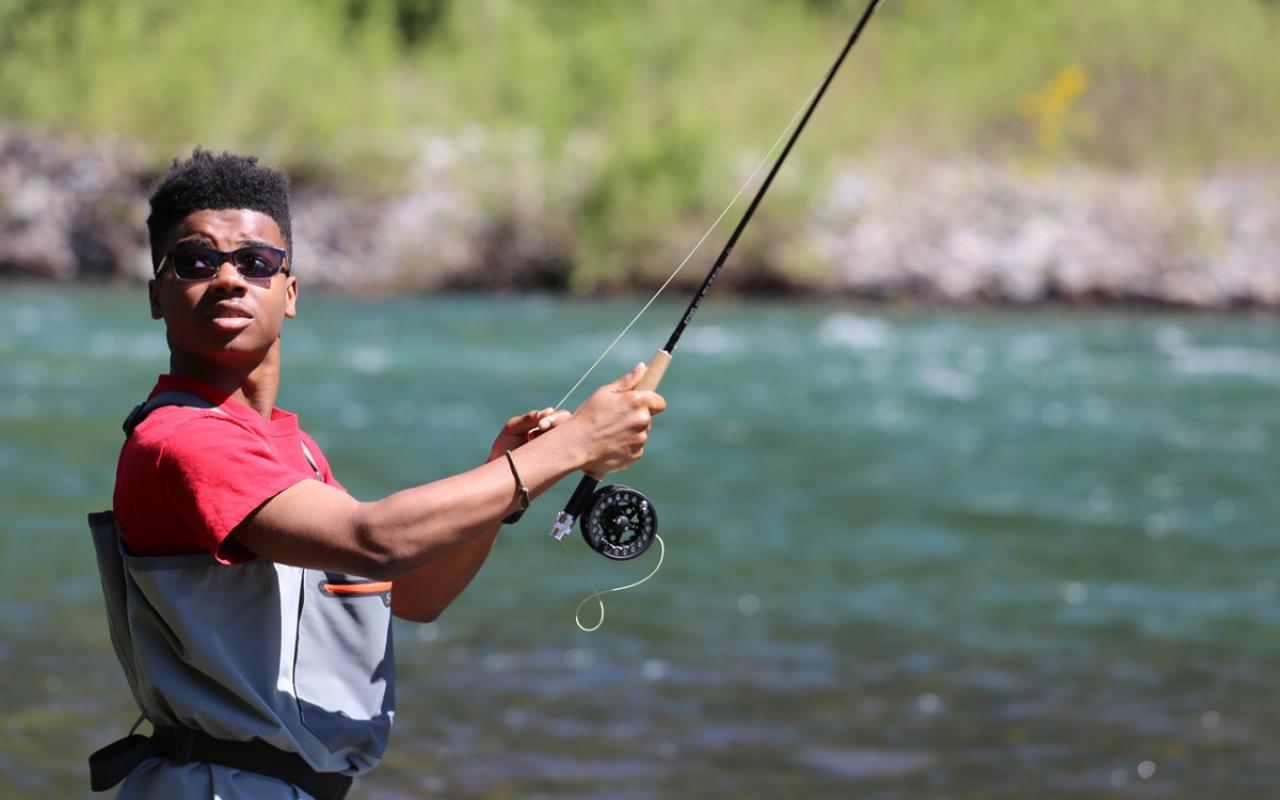 Photo caption: A youth draws his fishing line during Soul Rivers' three day excursion on the Middle Fork Willamette River