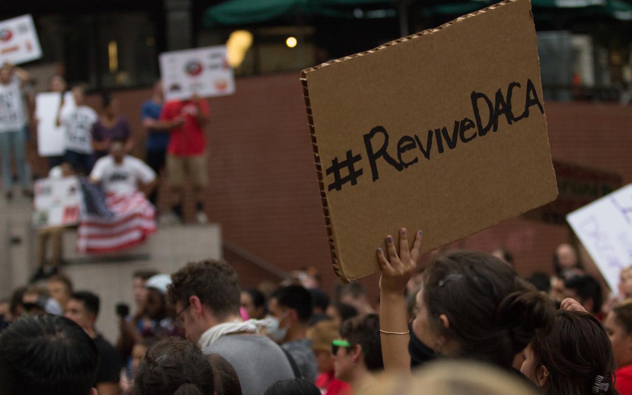 A demonstrator at a Portland DACA rally holds a sign that reads "Revive DACA" 