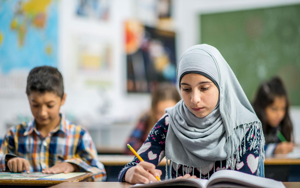 Photo caption: Two students reading during a class session.