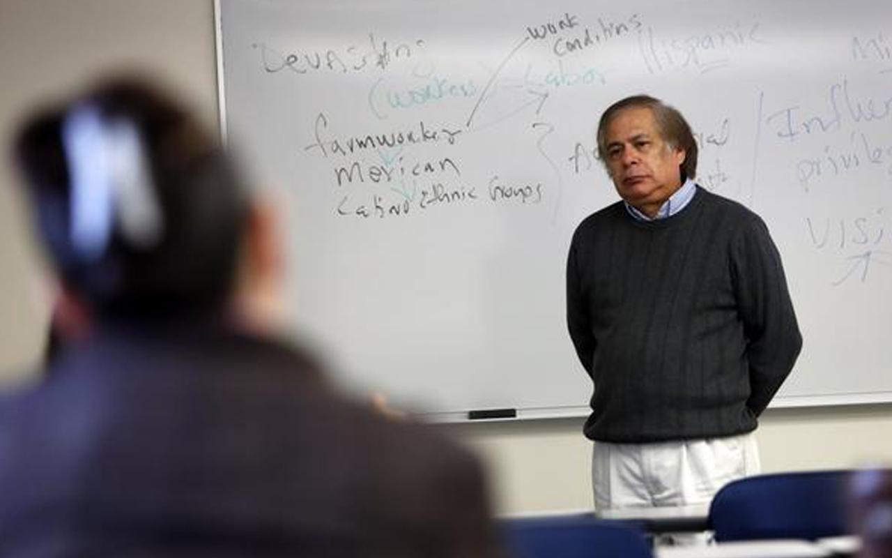 Jim Garcia, coordinator of Lane Community College’s Chicano/Latino Student Program, listens to a student while teaching. Photo credit: Andy Nelson at The Register-Guard