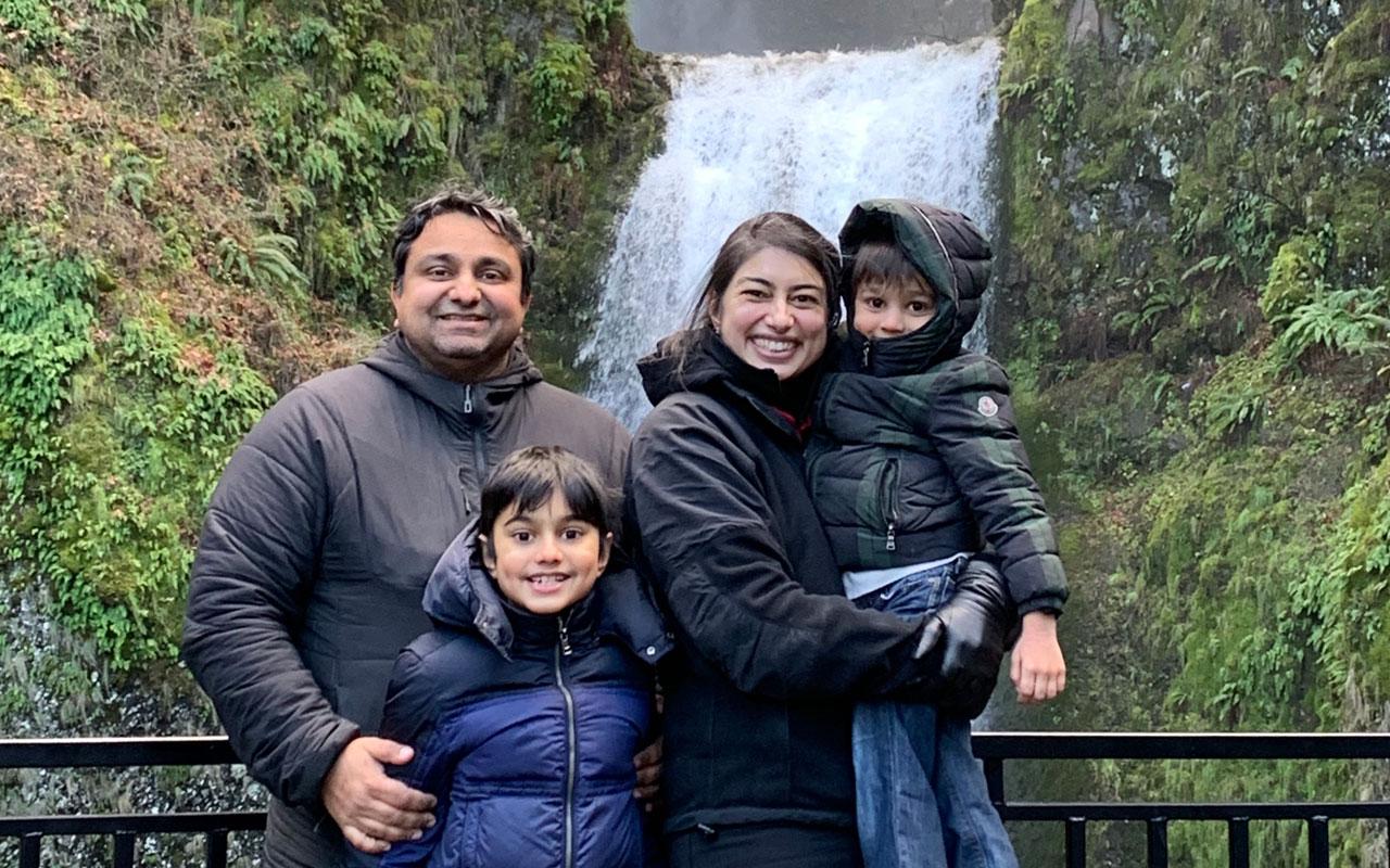 From left to right, Vikram, Vikas, Kaberi and Kavi smile for a family photo in front of Multnomah Falls.