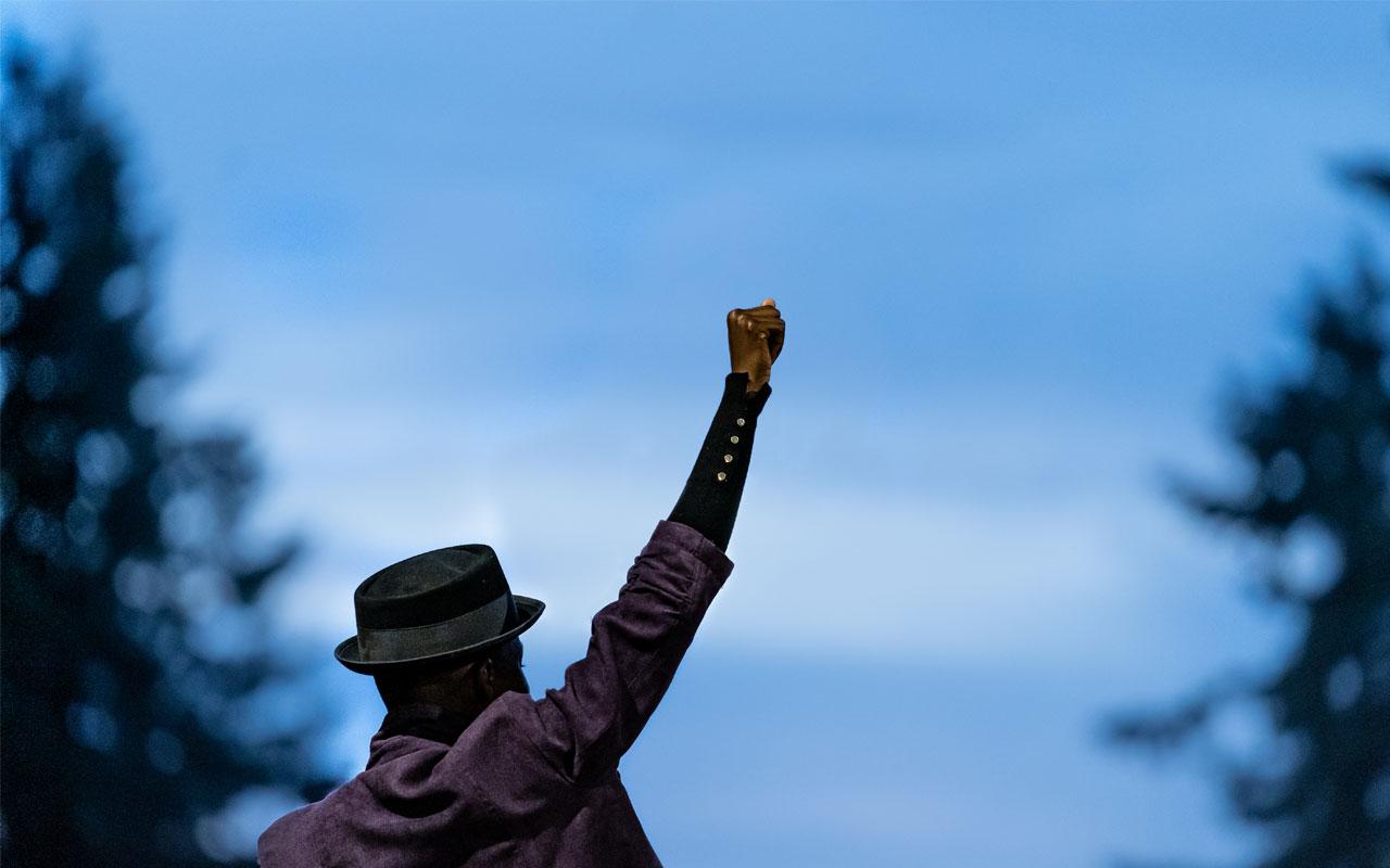 A poet raises their fist in solidarity during a protest in Portland in support of justice for Black lives. Photo credit: Fred Joe photo