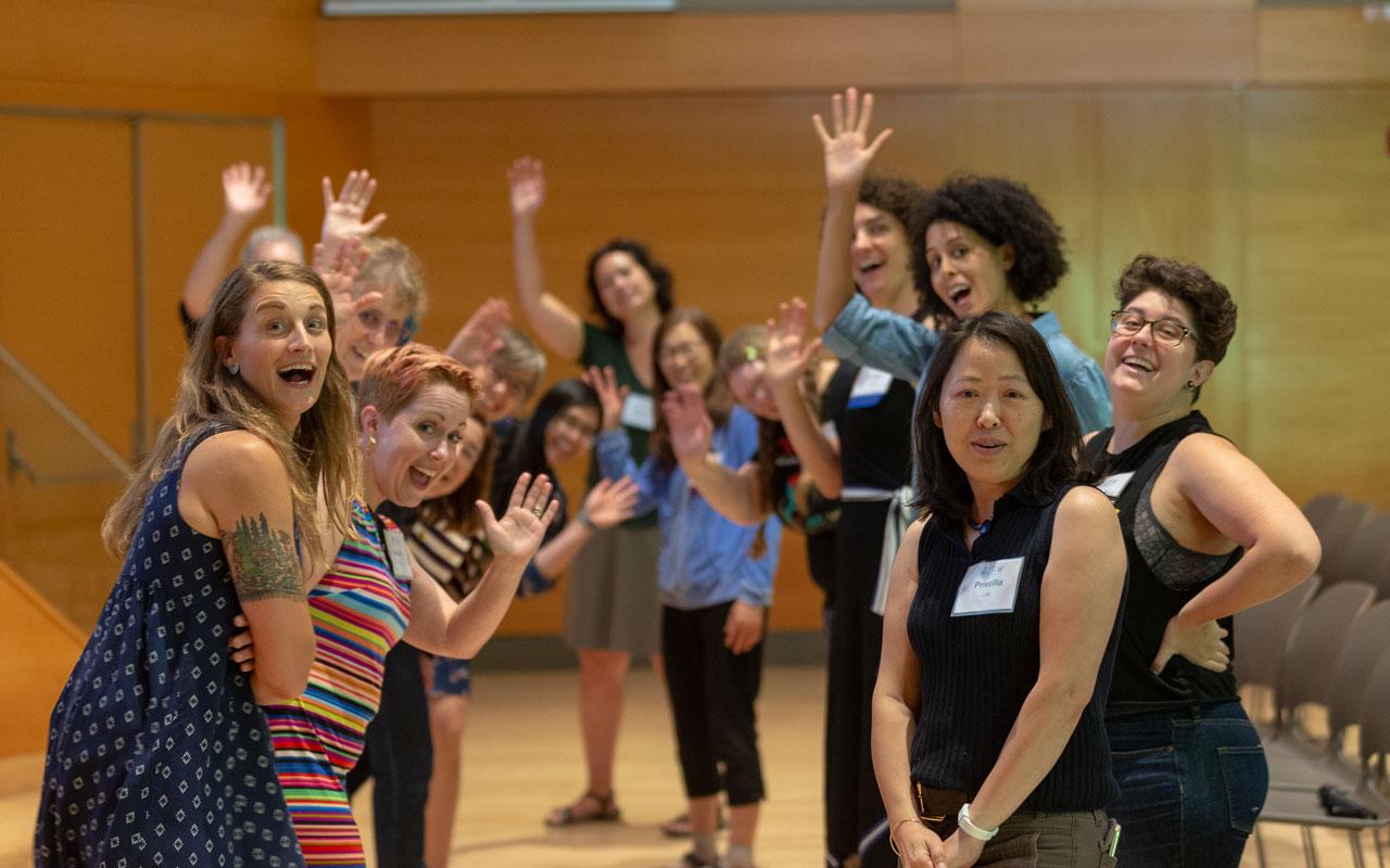 Photo caption:  Participants at the 2018 Advancing the Careers of Technical Women (ACT-W) Conference in Portland smile and wave in anticipation of their next workshop activity. 